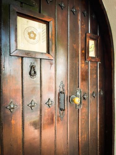 a wooden door with a picture on top of it at At Wind Chimes Boutique Hotel in San Juan
