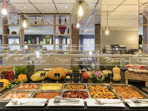 a buffet line with many different types of food at Mercure Hotel Amsterdam West in Amsterdam