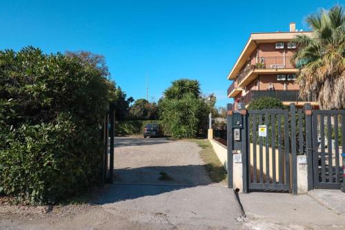 a gate to a house with a car parked in the driveway at Masi House in La Massimina-Casal Lumbroso