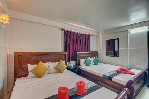 Postel nebo postele na pokoji v ubytování Siem Reap Pub Hostel