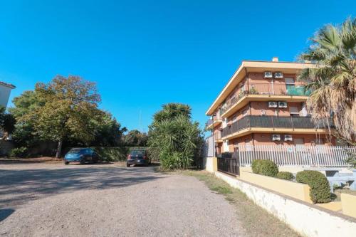 a building with cars parked in a parking lot at Masi House in La Massimina-Casal Lumbroso