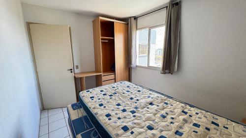 een slaapkamer met een bed in een kamer met een raam bij Apartamentos Aquarius Flat in Caldas Novas
