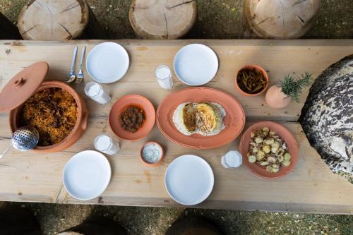 a wooden table with plates of food on it at بيت أبي علي in Abha