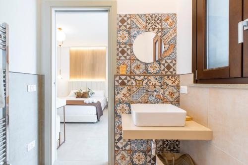 a bathroom with a sink and a mirror at Bed and Breakfast Nilu' in Castellammare del Golfo
