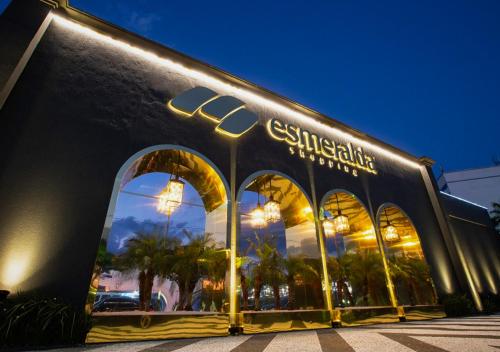 a store front of a building with large windows at Flat Apartamento Av Esmeralda em Marília in Marília