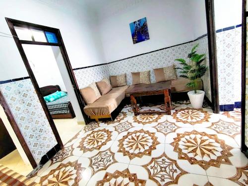 a living room with a couch and a mirror at CASA Marwane in Chefchaouen