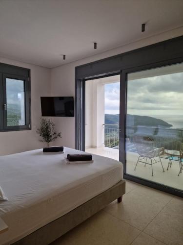 a bedroom with a bed and a view of the ocean at Seeview Villa and Mountain view in Grizókambos