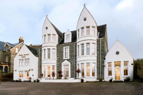 a large white house with turrets at Muthu Queens Hotel, Oban in Oban