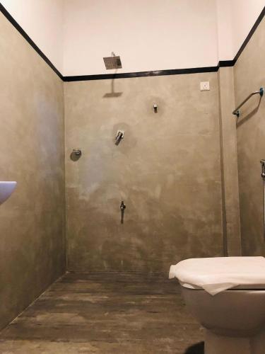 a bathroom with a toilet and a shower stall at Nimal's villa in Midigama East