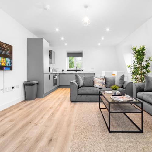 a living room with a couch and a table at Modern Two Bed Apartment - Netflix - Balcony - Parking - 5MC in Birmingham