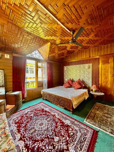 a bedroom with a bed and a rug on the floor at Vanda Heritage Houseboats in Srinagar