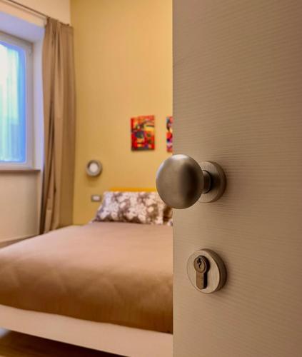 a bedroom with a door with a bed in it at BIXIO40 BED&BREAKFAST and APARTMENTS in Montefiascone