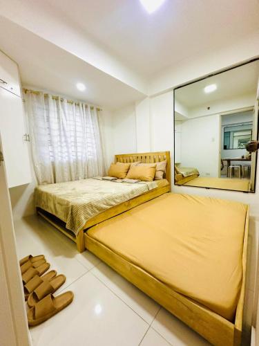 a bedroom with a large bed and a large mirror at 2BR Burnham Hill Condominium in Baguio