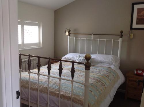 a bedroom with a bed and a window at The Stable in Stourton in Stourbridge