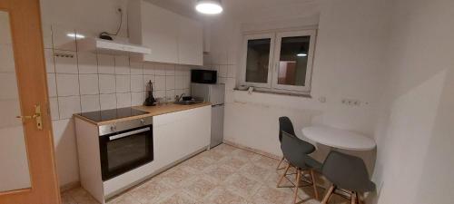 una cucina con due sedie, un tavolo e un bancone di Haus15 a Rüsselsheim