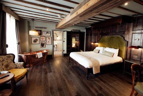 a bedroom with a large bed and a couch at The Wildings Northumberland in Morpeth