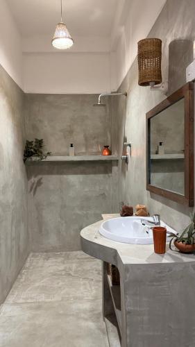 a bathroom with a sink and a mirror at Kataragama Homestay in Kataragama