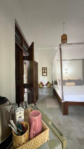a room with a bed and a basket of items at Kataragama Homestay in Kataragama