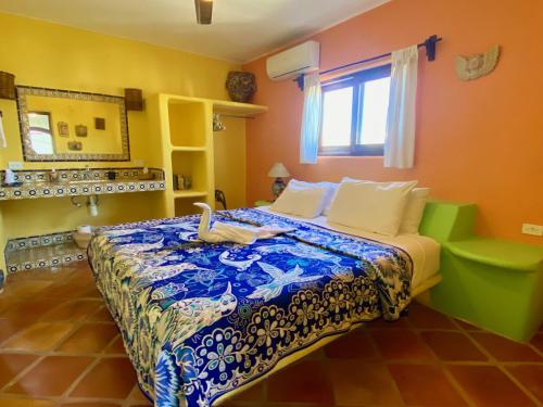 a bedroom with a bed with a swan on it at Estrella - Casa MoJo's airy 2BR, kitchen, pool in Sayulita