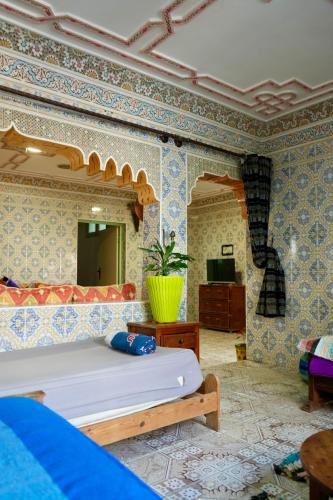 a bedroom with a bed and a mirror at tamazirt surf house in Taghazout