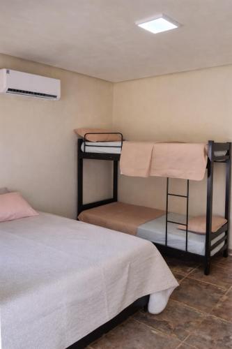 a room with two bunk beds and a bed at Casa na lagoa do Paraíso- Villa Bem Estar in Jericoacoara