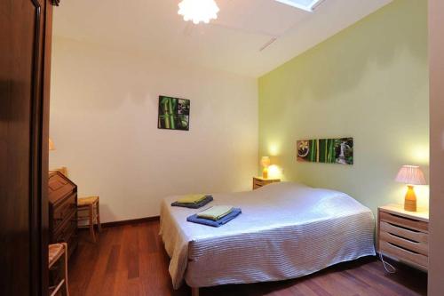 a bedroom with a bed and a table and a lamp at Cecile in Montgaillard