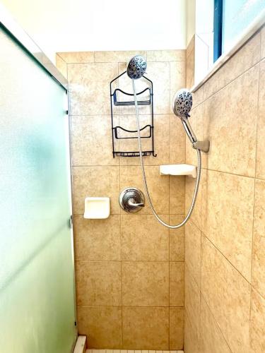 a shower in a bathroom with a glass door at Loft à louer in Apollo Beach