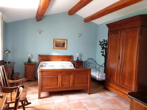 una camera da letto con un letto e un armadio in legno di Bergerie de la bueges a Saint-André-de-Buèges