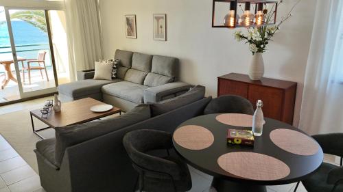 a living room with a couch and a table at MaraHomes in Funchal