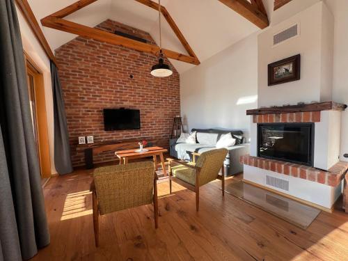 a living room with a couch and a fireplace at Iža na brejgi in Moravske-Toplice