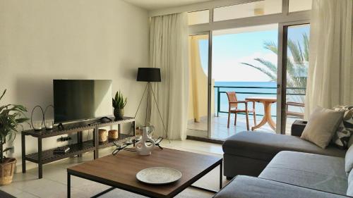 a living room with a couch and a table at MaraHomes in Funchal