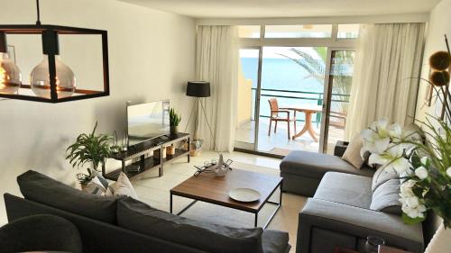 a living room with a couch and a table at MaraHomes in Funchal