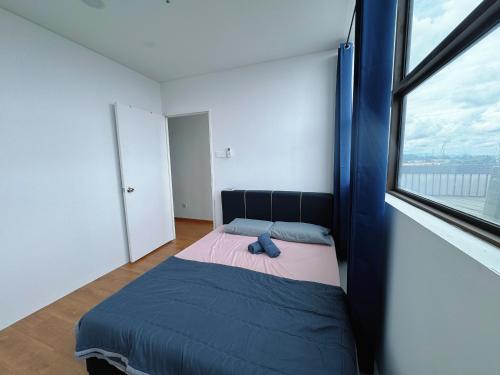 a bedroom with a bed with a large window at Make Memories Residence 2BR Summer Mall Kota Samarahan in Kota Samarahan