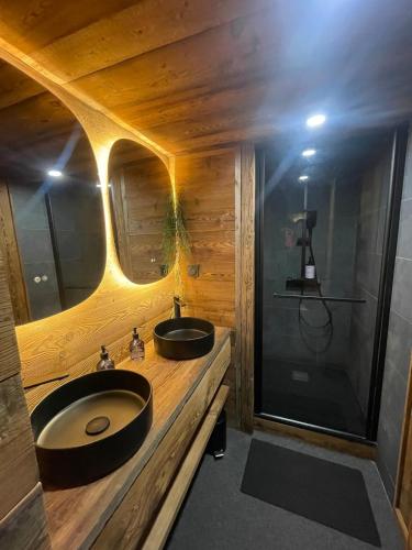a bathroom with two sinks and a shower at Chalet de ZORE in Morzine