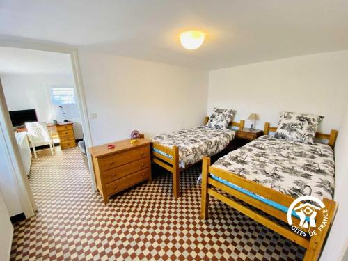 En eller flere senge i et værelse på Au bien-etre