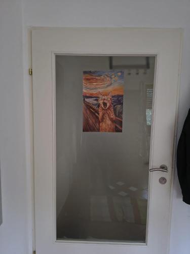 a framed picture of a cat on a wall at Juls garden apartment in Tulln
