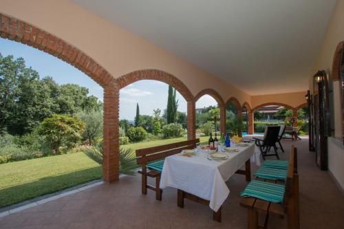a dining room with a table and chairs on a patio at Daller Bianca by Whale Homes in Soiano del Lago