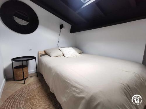 een slaapkamer met een wit bed en een zwart plafond bij Copatito in Cap d'Agde