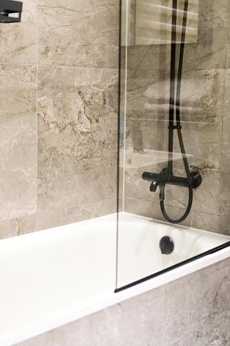 a shower in a bathroom with a glass door at Luxury 2bed flat around Manchester Victoria St in Manchester
