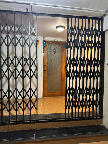an iron gate with a door in a hallway at Meridian penthouse in Kolhapur
