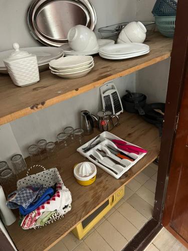 a shelf with plates and utensils in a kitchen at Entire Ocean-View Apartment in Rabat