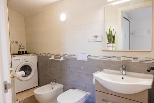 a bathroom with a sink and a washing machine at Cairoly Residence in Termoli