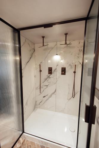 a bathroom with a shower with a glass door at The Wildings Northumberland in Morpeth
