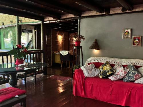 a living room with a couch and a table at Pousada Magia da Mata in Trindade