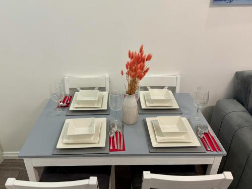 a blue table with plates and napkins on it at Modern Elegant Home in Portsmouth