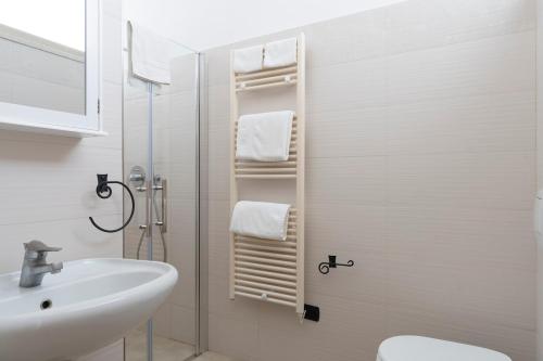 a bathroom with a sink and a toilet and a shower at Mondial Beauty Suite in Bellaria-Igea Marina