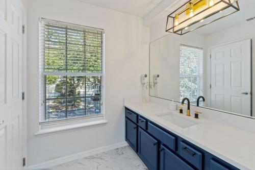 a bathroom with a sink and a mirror at Enjoyable 6BR Home Near Disney in Orlando