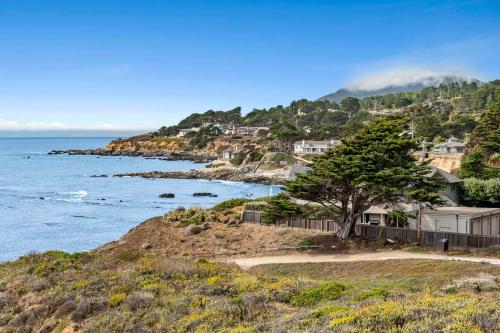 a house on a hill next to the ocean at Oceanview Beach Home Walk to Beach Trails Food Family Activities in Montara