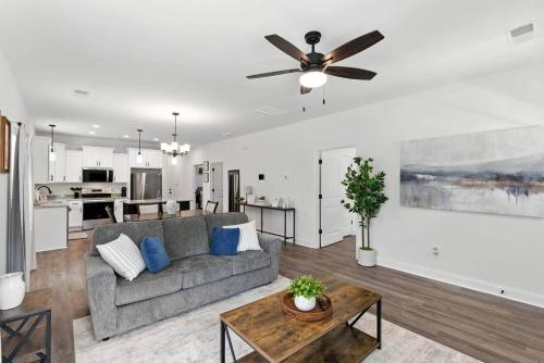 a living room with a couch and a ceiling fan at Heart of Cedartown | 0.3 miles from the Silver Comet Trail in Cedartown