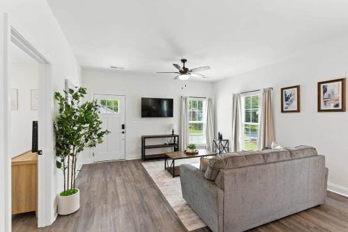 a living room with a couch and a tv at Heart of Cedartown | 0.3 miles from the Silver Comet Trail in Cedartown